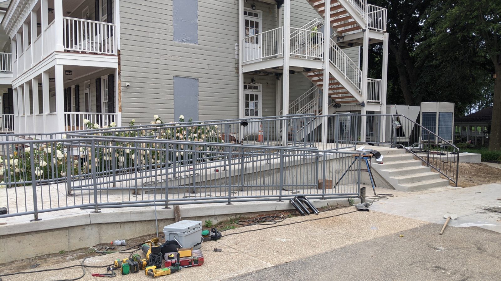 Fabricated steel handrail and ramp installed on a building exterior